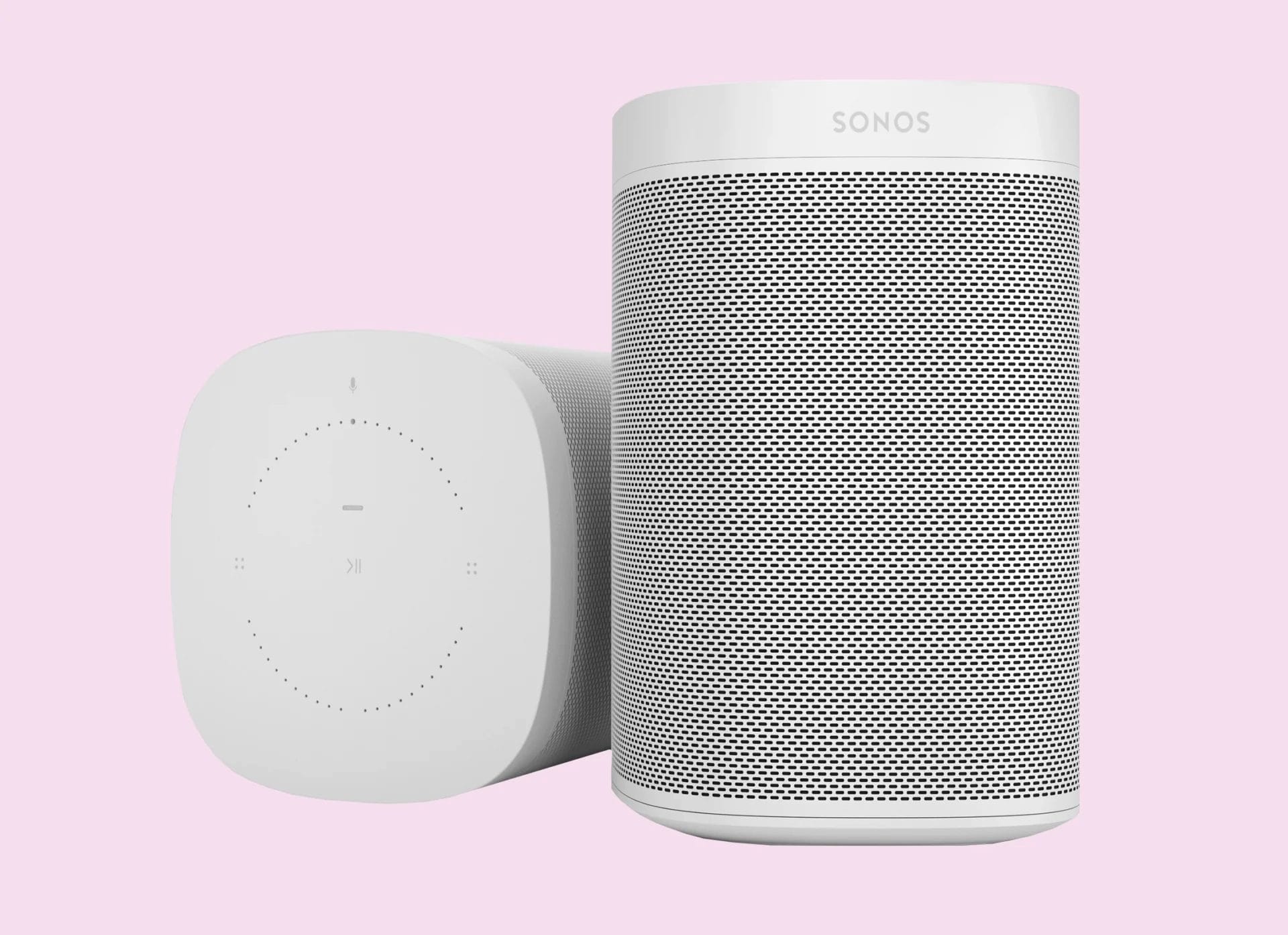grey modern speakers against a pale pink background